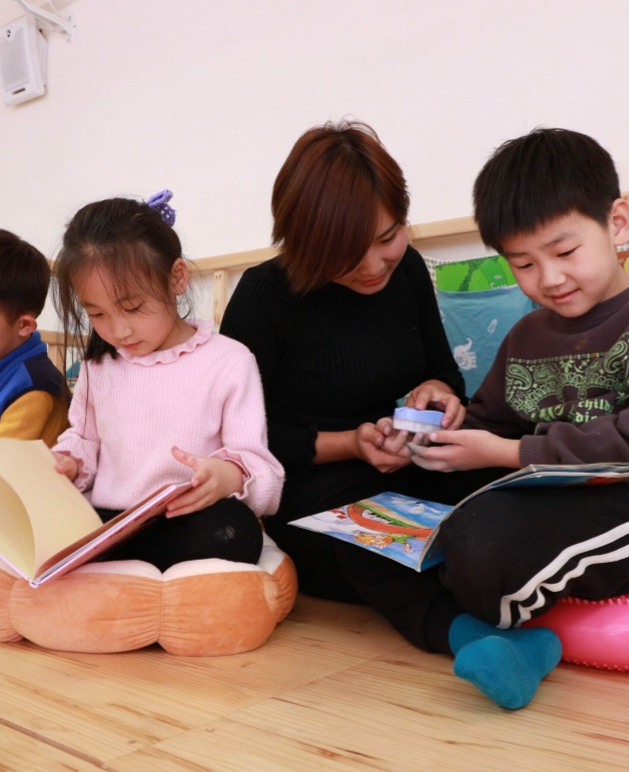     Children sitting on the floor reading books