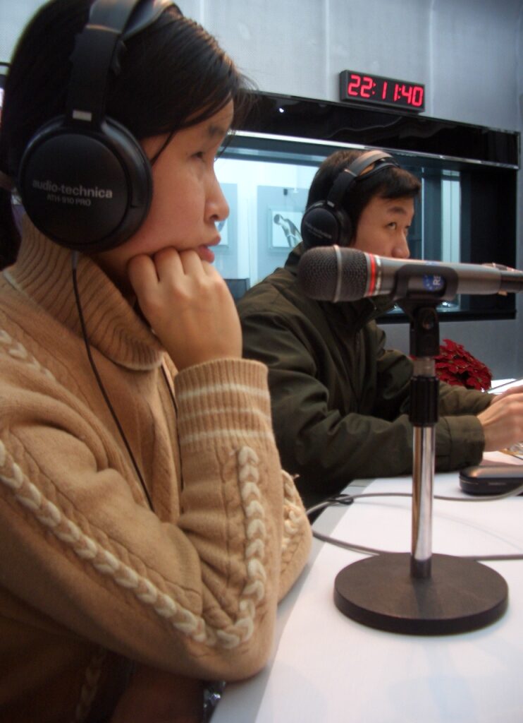     Visually impaired broadcasters in front of microphone in studio 