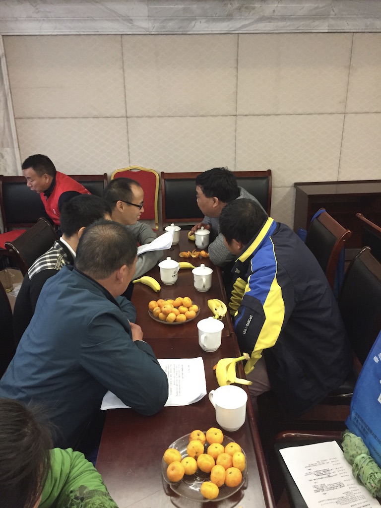     Group discussion around table with bowl of fruit